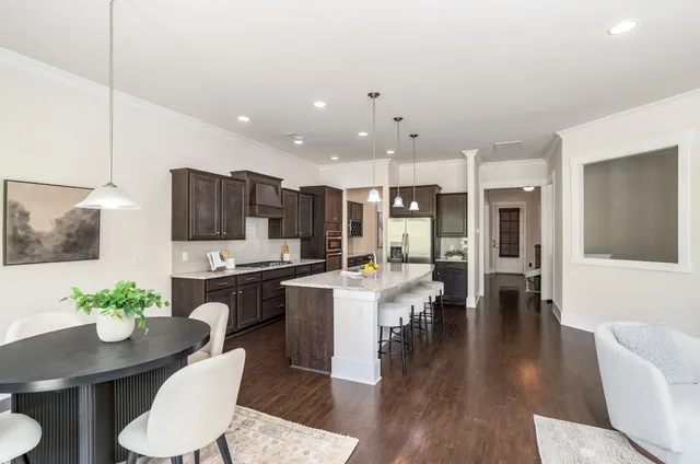 a living room with lots of furniture and view of kitchen