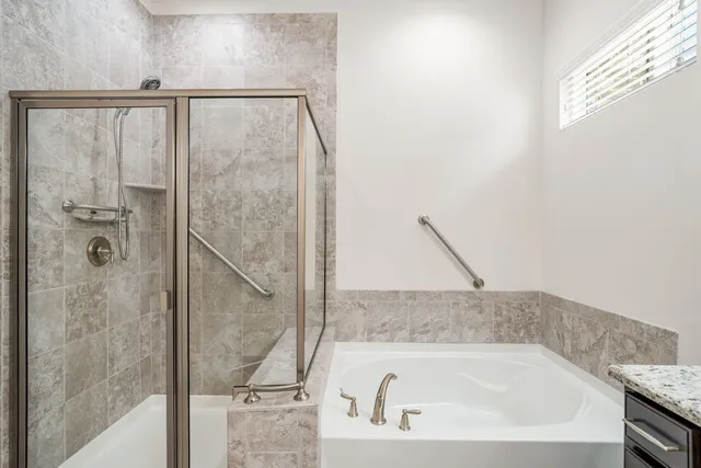 a bathroom with a bathtub and shower