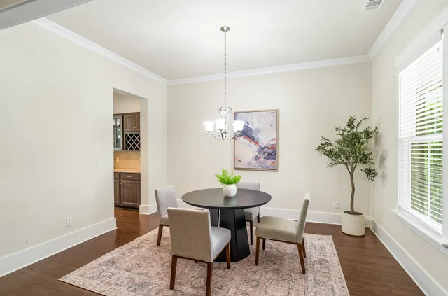 a kitchen with stainless steel appliances granite countertop a sink a stove and a wooden floors