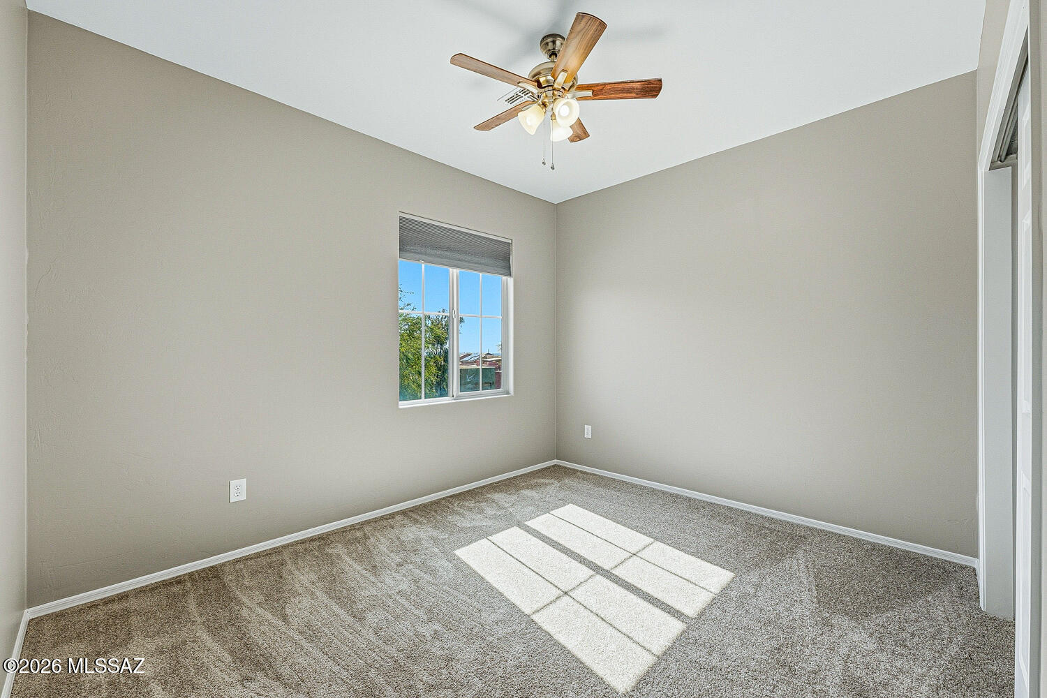 323 East Refuge Loop Vail, AZ 85641 - Photo 41 of 51 an empty room with windows and ceiling fan