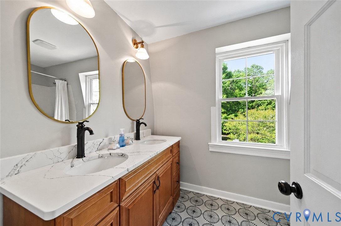 20010 River Road Chesterfield, VA 23838 - Photo 28 of 36 a bathroom with a double vanity sink and a mirror
