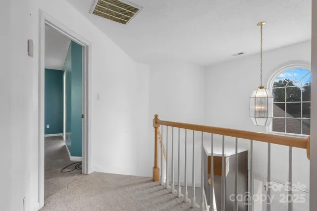 a view of a hallway with windows