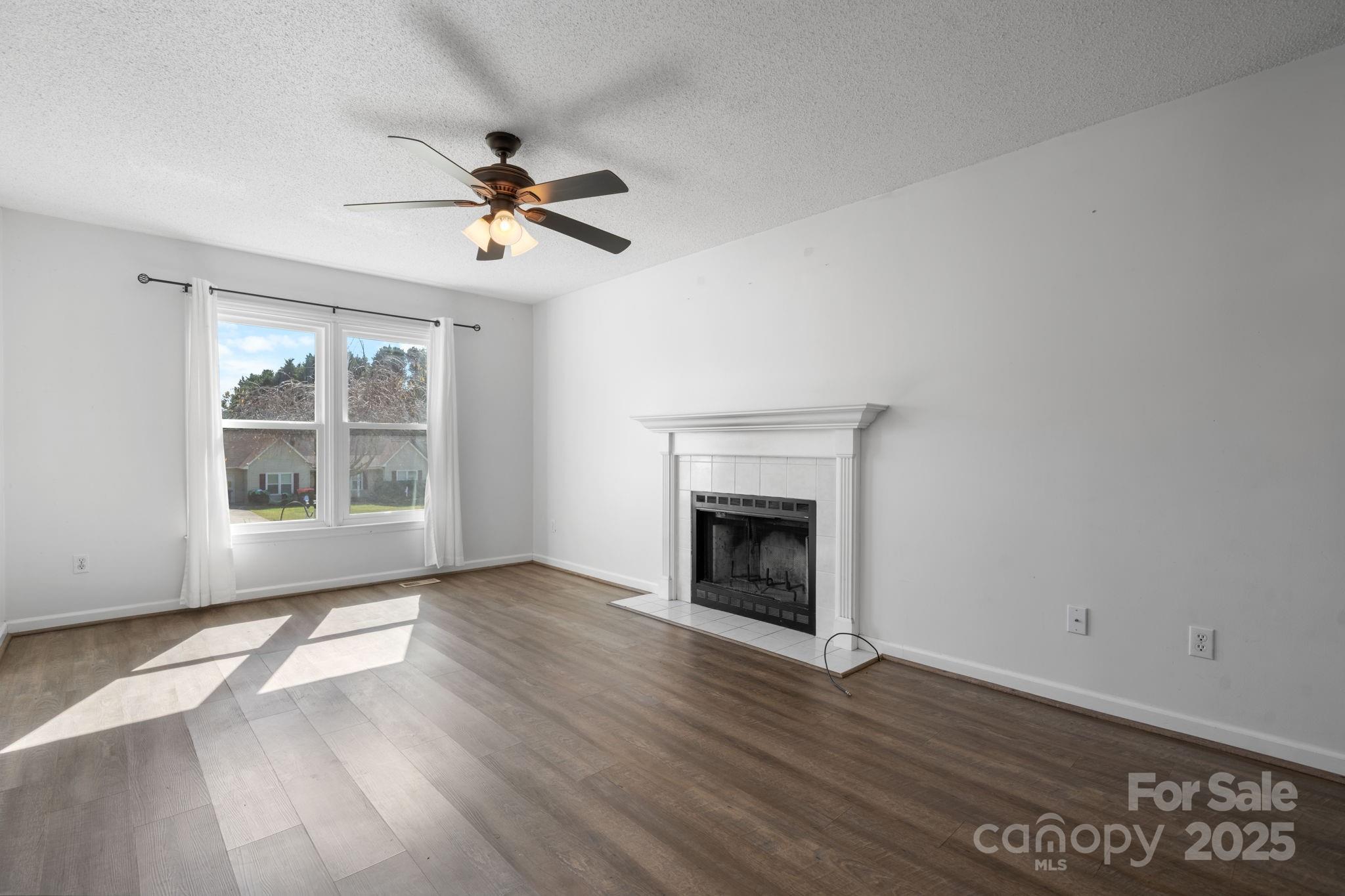 712 Painted Feather Lane Conover, NC 28613 - Photo 3 of 48 a view of empty room with wooden floor and fan