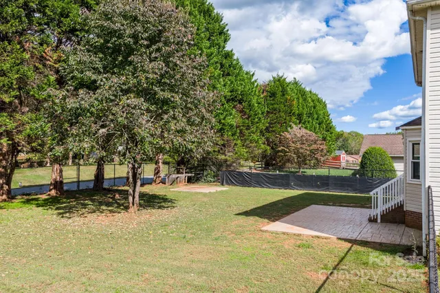 a view of a yard with swimming pool