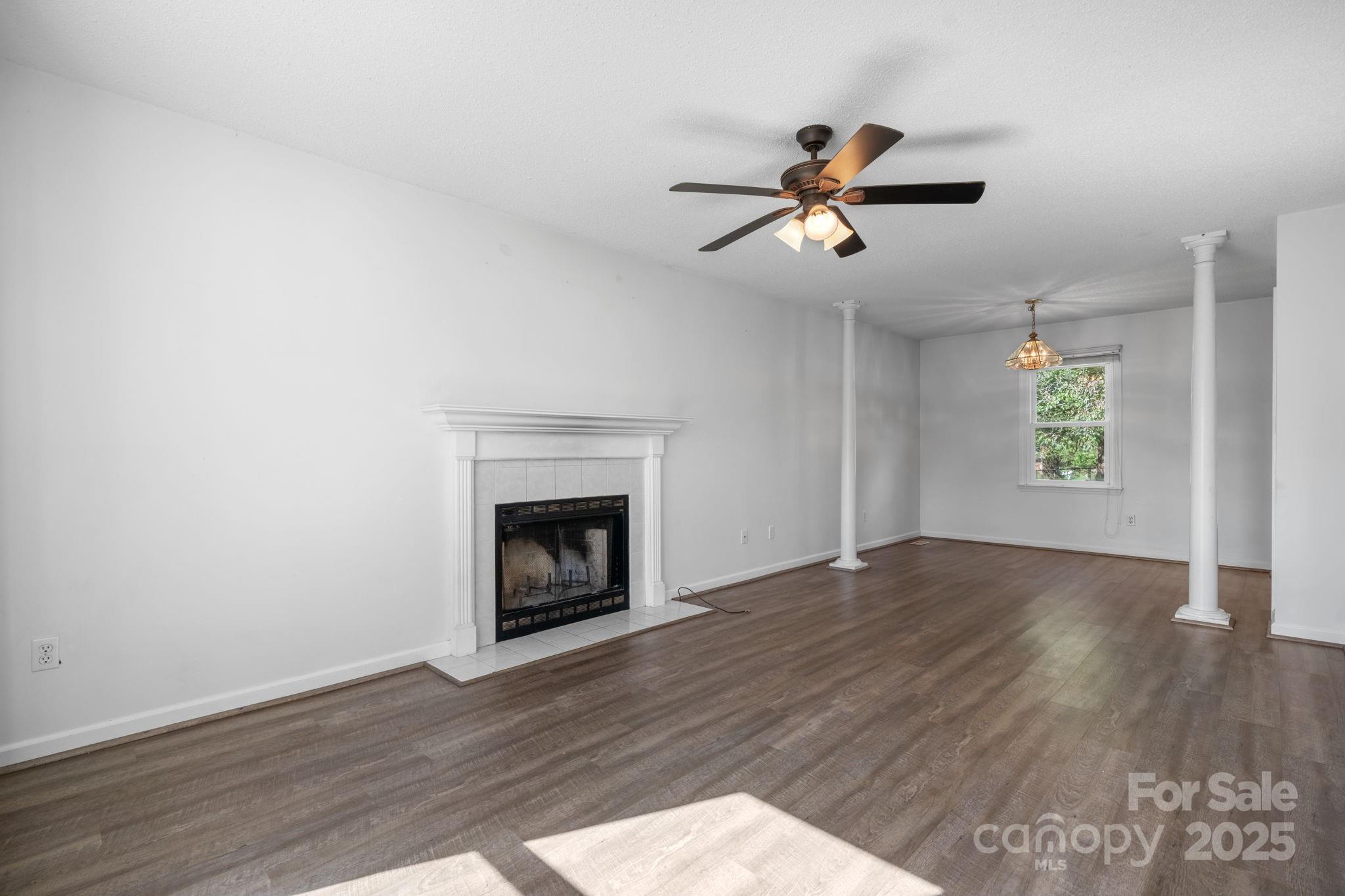 712 Painted Feather Lane Conover, NC 28613 - Photo 5 of 48 a view of empty room with wooden floor and fan