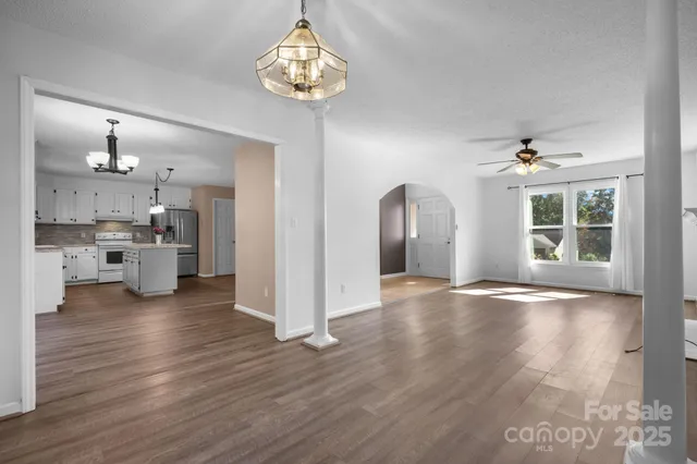 a view of a kitchen with furniture wooden floor and a kitchen