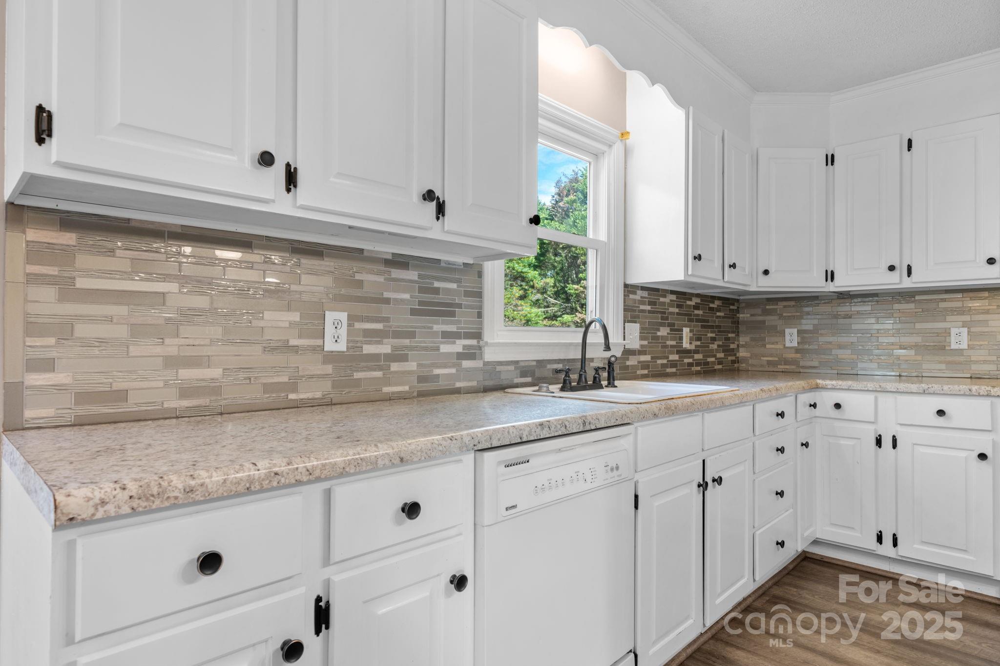 712 Painted Feather Lane Conover, NC 28613 - Photo 10 of 48 a kitchen with granite countertop white cabinets and white appliances