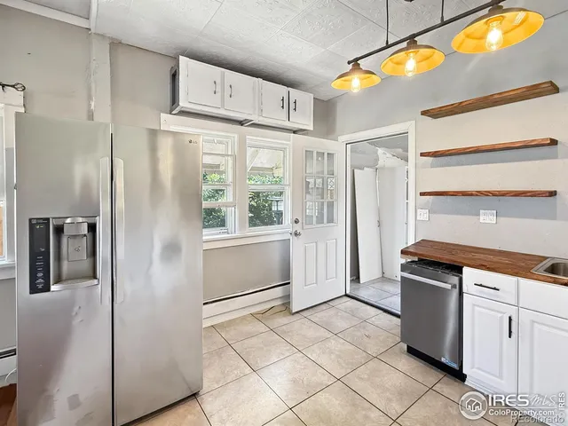 a kitchen with stainless steel appliances a refrigerator and a stove