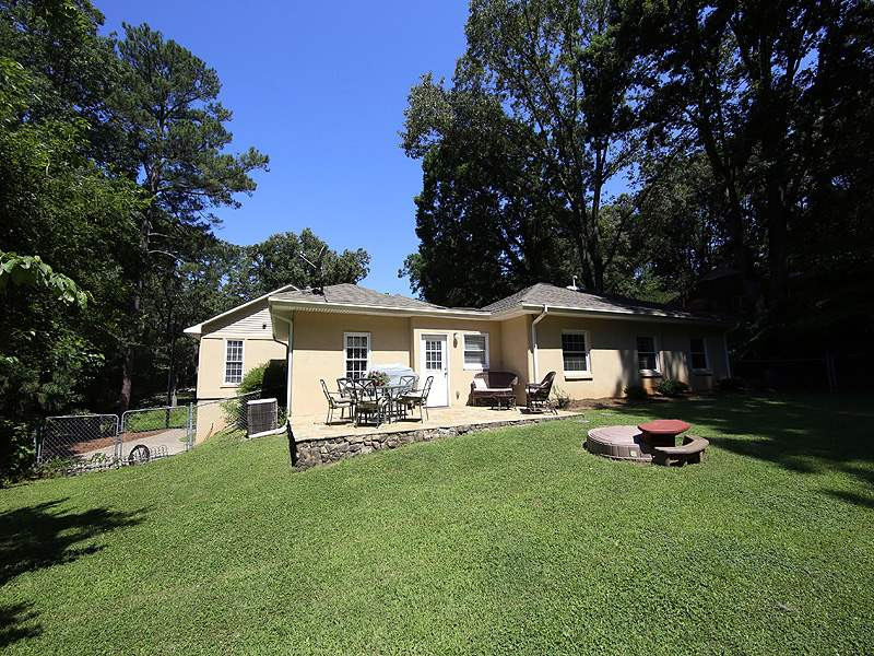 1315 Chaney Road Raleigh, NC 27606 - Photo 24 of 25 Enjoy the stone patio overlooking the private, fenced backyard. Exterior Back