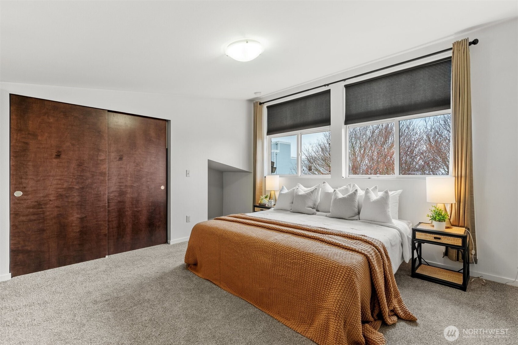 6536 42nd Avenue Southwest, Unit B Seattle, WA 98136 - Photo 16 of 27 a bedroom with a bed and a large window