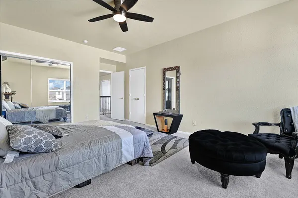 a bedroom with a bed and a couch