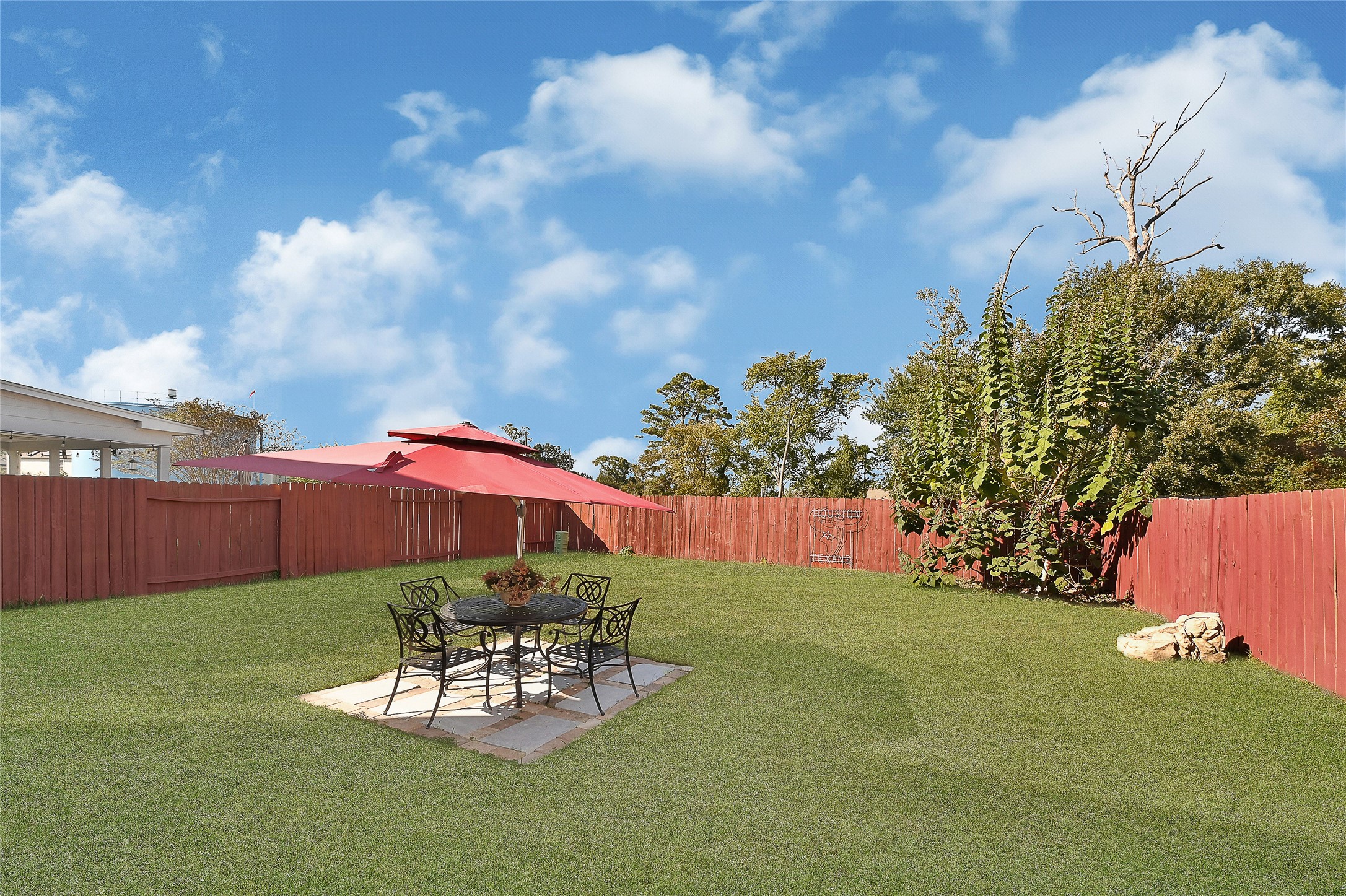 16107 Sheldon Ridge Way Houston, TX 77044 - Photo 25 of 27 a view of a backyard with table and chairs potted plants and wooden fence