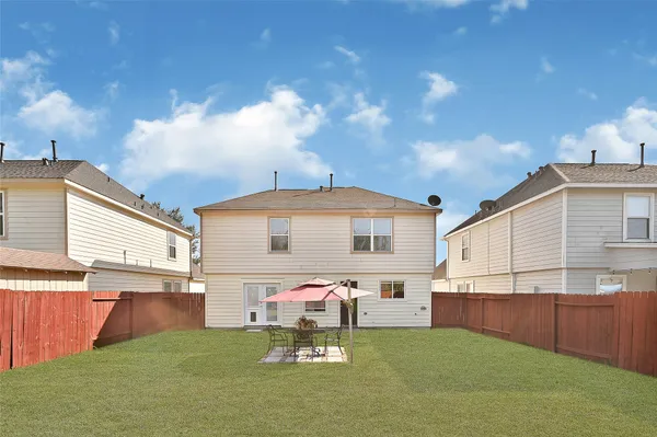 a view of a backyard with a sitting area