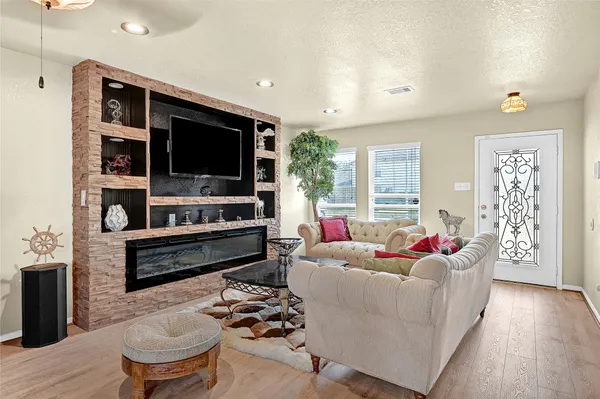 a living room with furniture and a flat screen tv