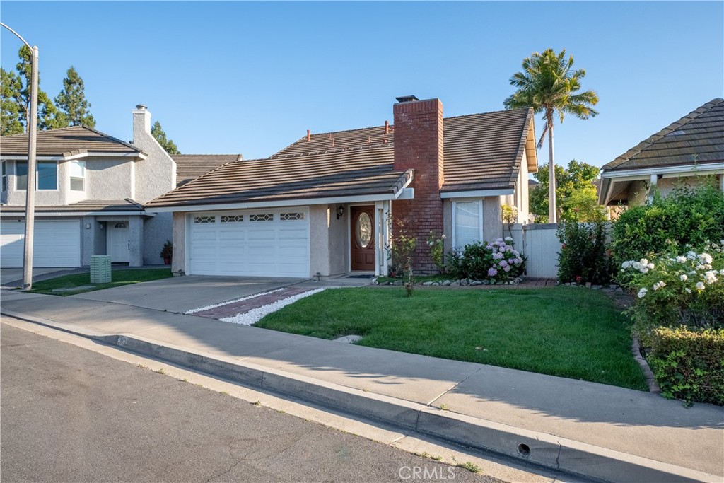 a front view of a house with a yard and a garage