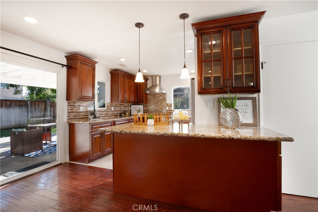 6 Sanderling Irvine, CA 92604 - Photo 13 of 35 a kitchen with stainless steel appliances granite countertop a sink a stove and a wooden floors