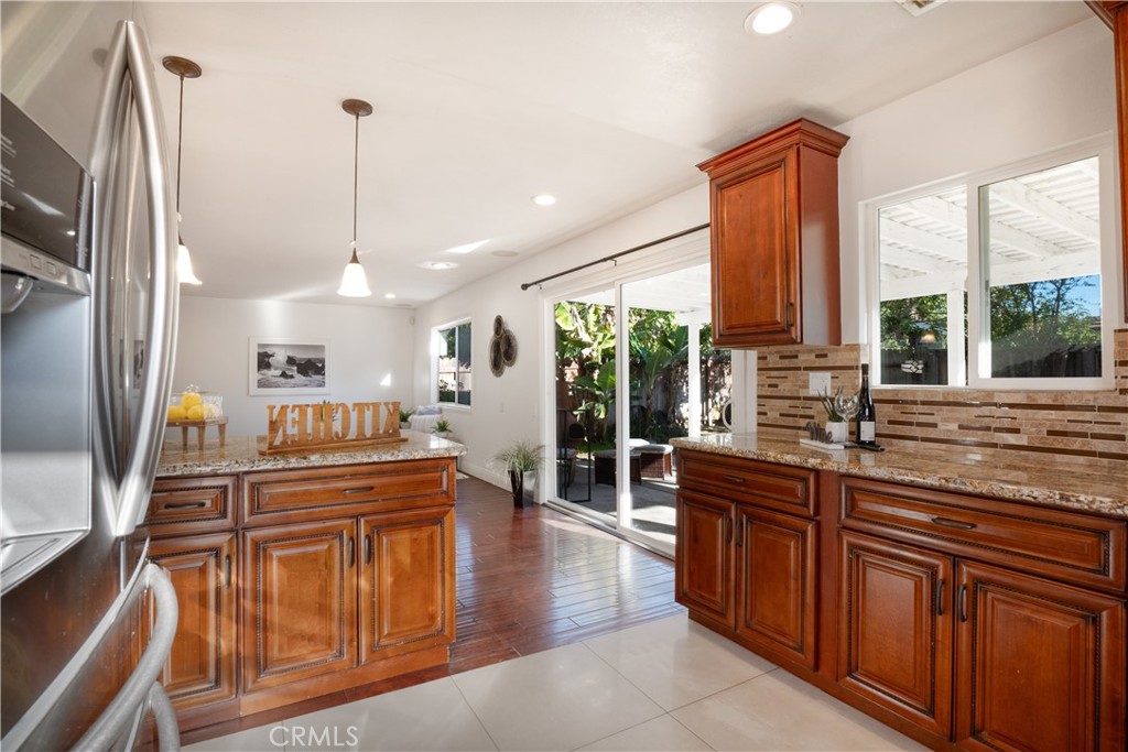 6 Sanderling Irvine, CA 92604 - Photo 14 of 35 a kitchen with stainless steel appliances granite countertop a sink and wooden cabinets