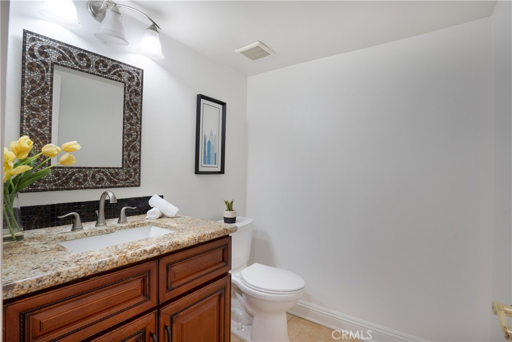 6 Sanderling Irvine, CA 92604 - Photo 17 of 35 a bathroom with a granite countertop sink and a mirror