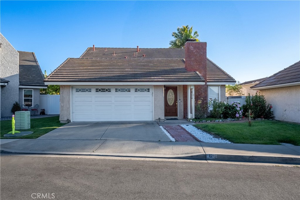 6 Sanderling Irvine, CA 92604 - Photo 2 of 35 a front view of a house with a yard and a garage