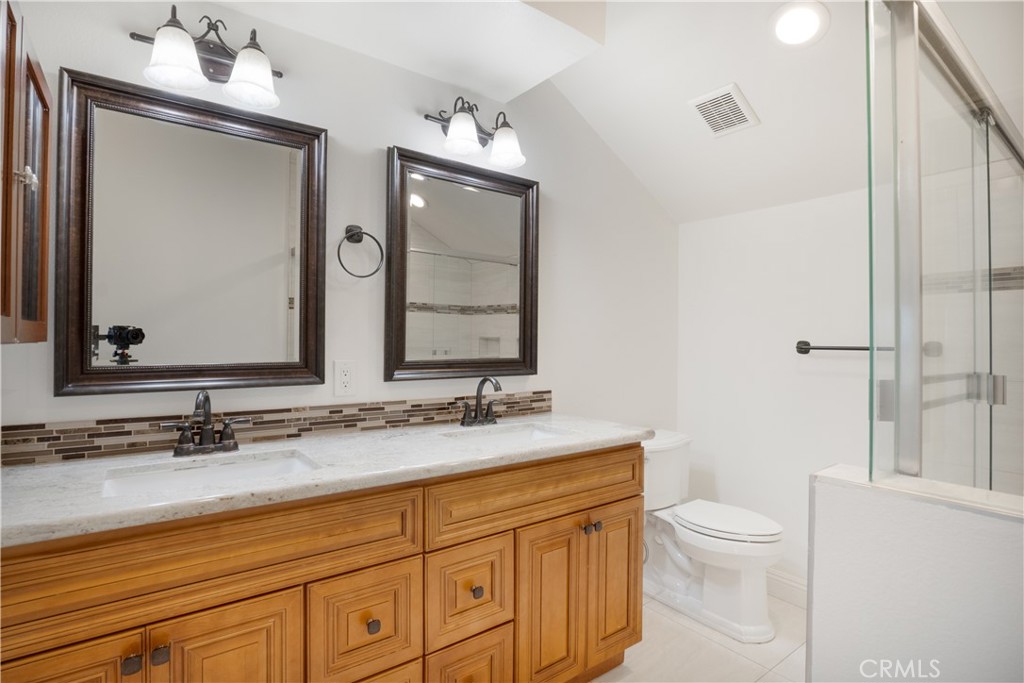 6 Sanderling Irvine, CA 92604 - Photo 27 of 35 a bathroom with a granite countertop sink vanity mirror and toilet