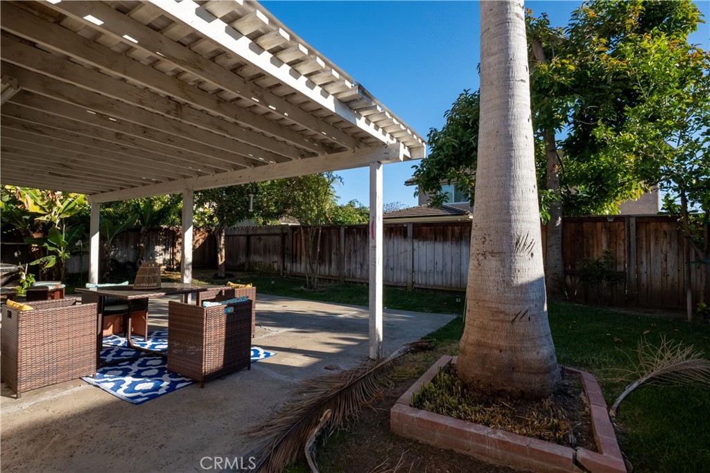 6 Sanderling Irvine, CA 92604 - Photo 34 of 35 a view of a patio with table and chairs potted plants with wooden fence