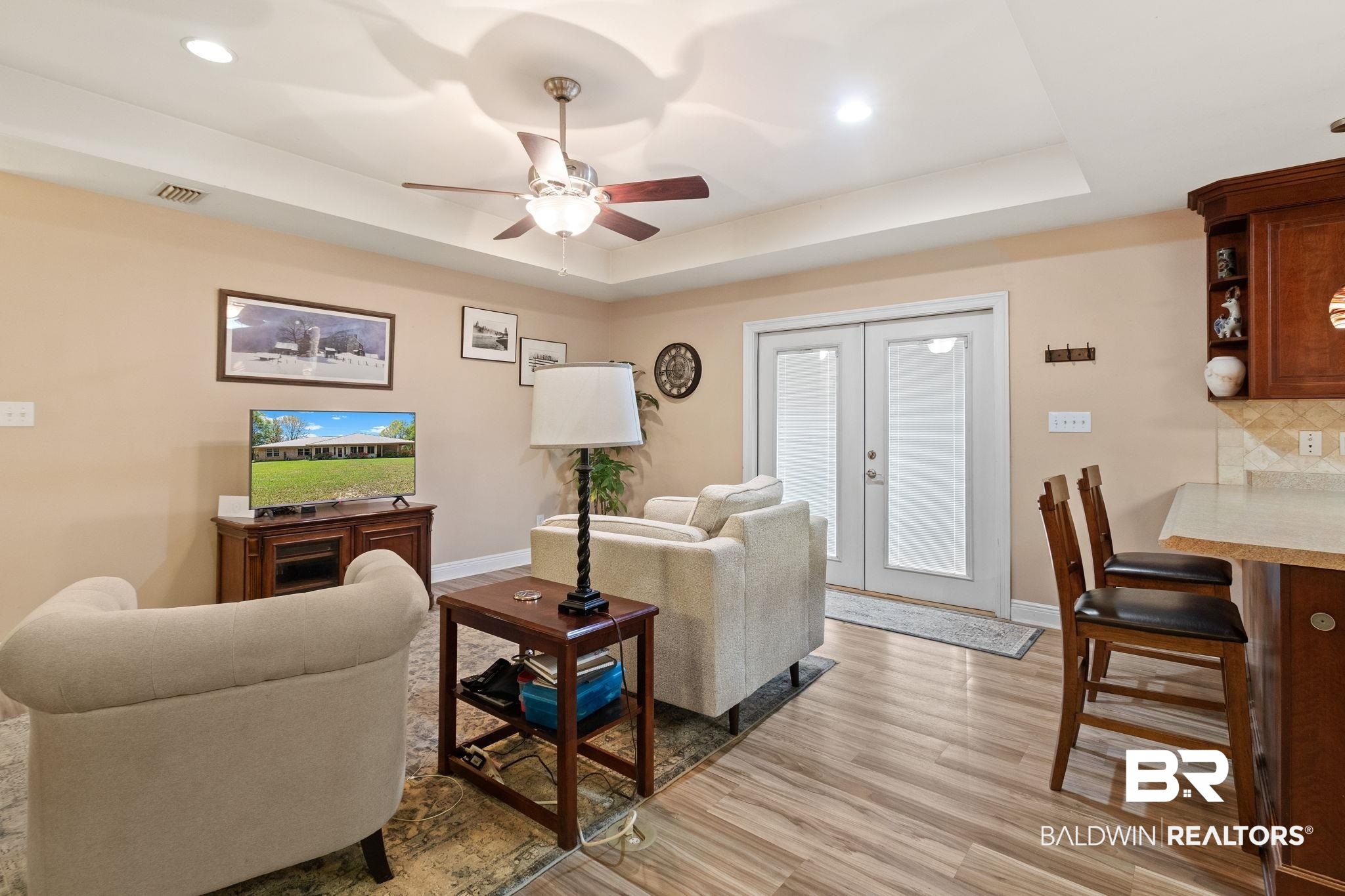 24250 Hack Road Bay Minette, AL 36507 - Photo 9 of 88 Living room featuring french doors, ceiling fan, light wood-type flooring, a tray ceiling, and recessed lighting