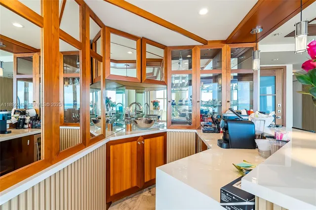 a large white kitchen with a large window
