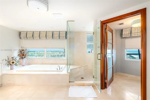 a bedroom with a large bed and a flat tv screen