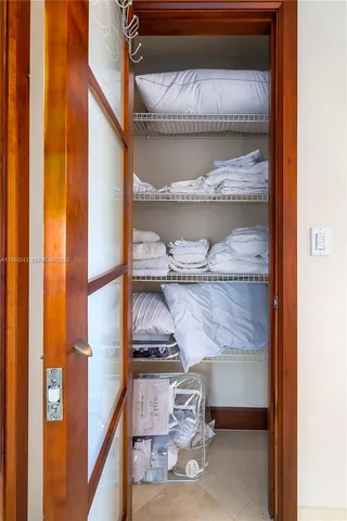 a living room with furniture a chandelier and a wooden floor