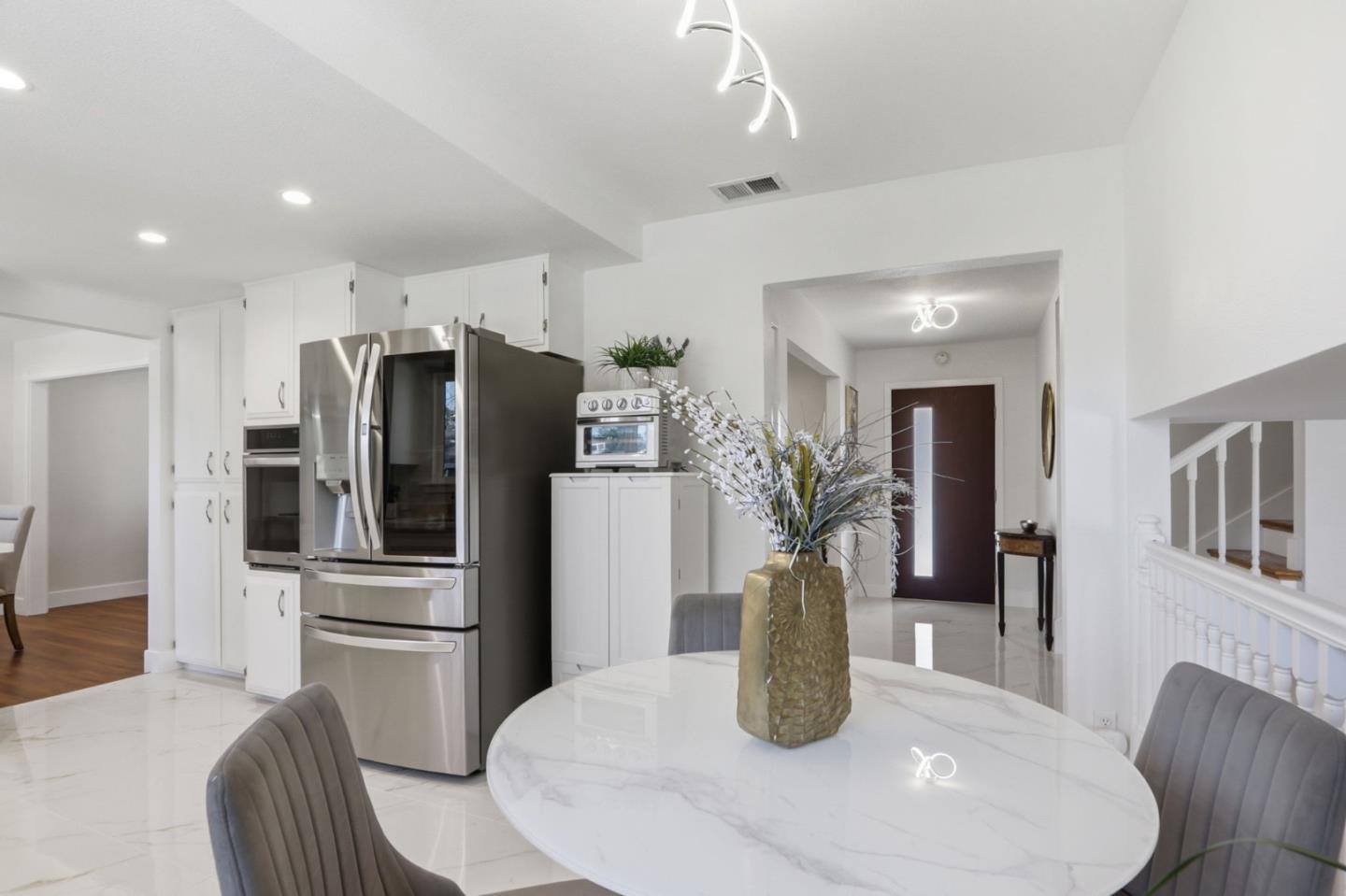 5888 Lean Way San Jose, CA 95123 - Photo 24 of 54 a kitchen with stainless steel appliances kitchen island granite countertop a refrigerator a stove a sink dishwasher with wooden floor dining table and chairs