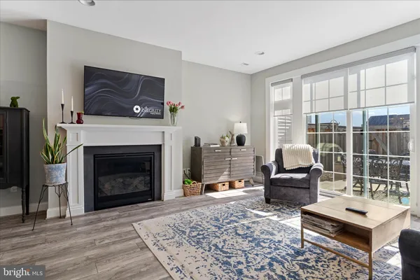 a living room with furniture a window and a fireplace