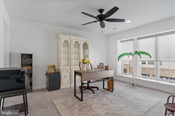 a view of a livingroom with furniture window and a ceiling fan