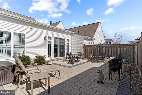 a view of a patio with table and chairs and potted plants
