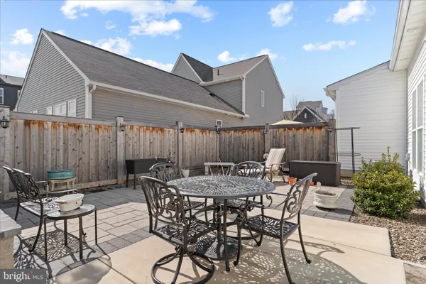 a view of a dinning table and chairs in the patio