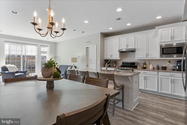 a kitchen with a table chairs stove and cabinets