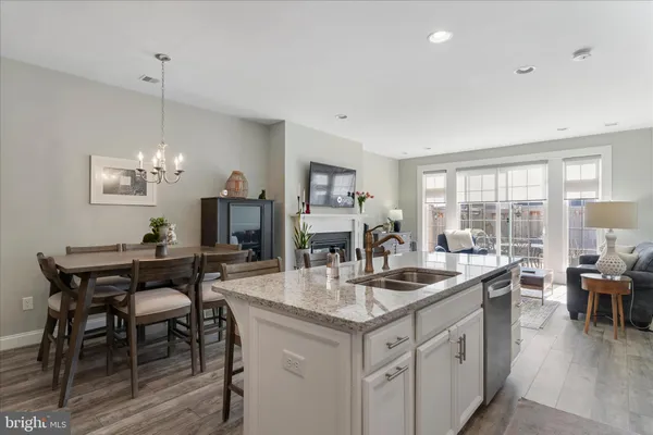 a open kitchen with stainless steel appliances granite countertop a sink and a refrigerator