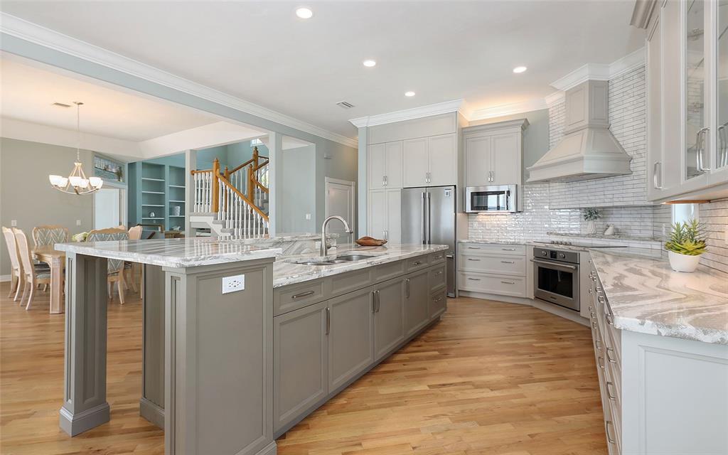585 Gunwale Lane Longboat Key, FL 34228 - Photo 28 of 73 a large kitchen with stainless steel appliances kitchen island granite countertop a large counter top and a stove top oven