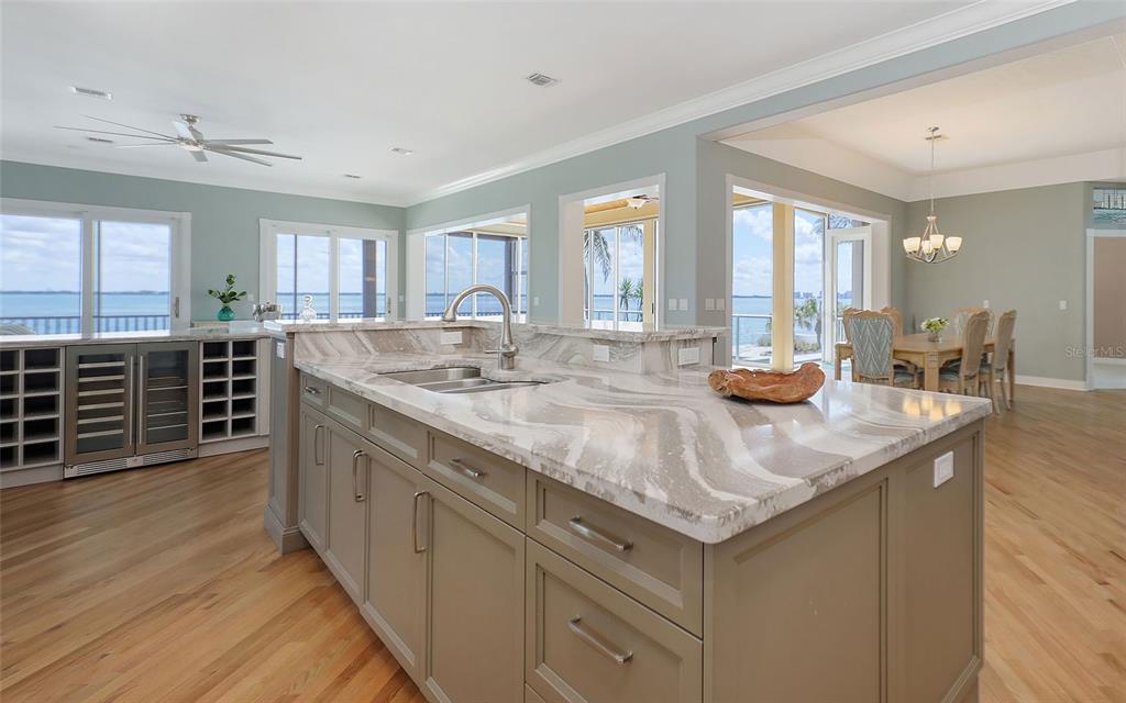 585 Gunwale Lane Longboat Key, FL 34228 - Photo 29 of 73 a kitchen with stainless steel appliances granite countertop a sink and a wooden floors