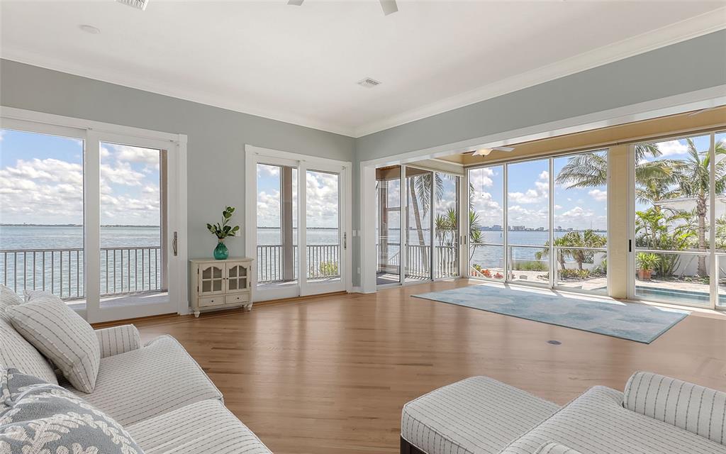 585 Gunwale Lane Longboat Key, FL 34228 - Photo 31 of 73 a living room with furniture and a large window with wooden floor