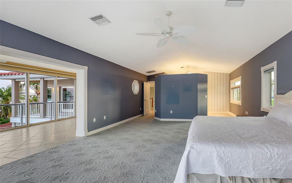 585 Gunwale Lane Longboat Key, FL 34228 - Photo 57 of 73 a large bedroom with a large bed and wooden floor