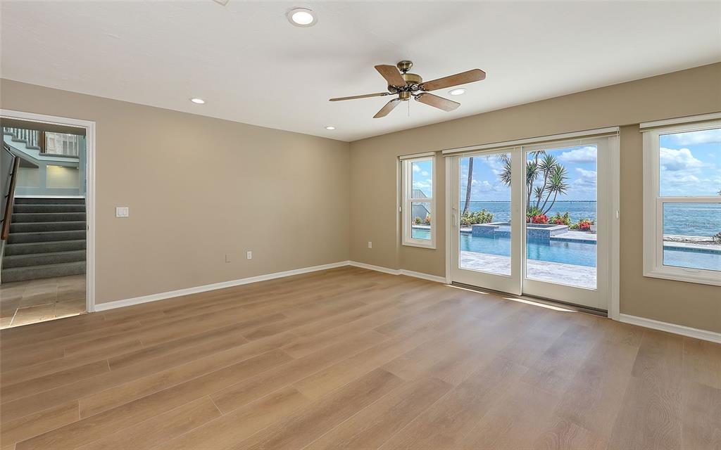 585 Gunwale Lane Longboat Key, FL 34228 - Photo 62 of 73 a view of an empty room with a window and wooden floor