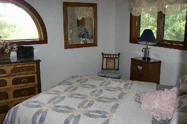 286 Snipe Hollow Road Elizabeth, IL 61028 - Photo 7 of 8 a bedroom with a bed and a flat tv screen on dresser