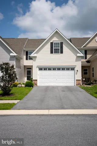 a view of backyard of house with garage