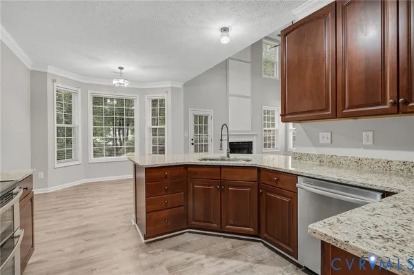 a kitchen with stainless steel appliances granite countertop a sink refrigerator and microwave