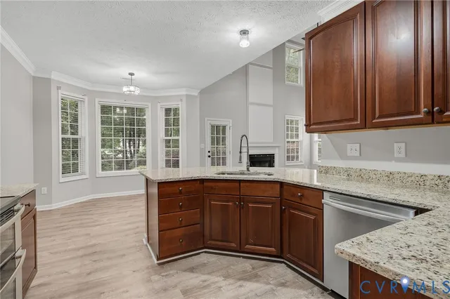 a kitchen with stainless steel appliances granite countertop a sink refrigerator and microwave