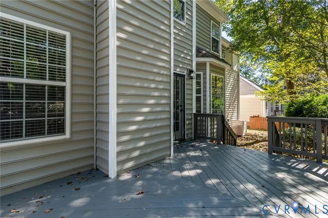 a view of house with a large window and wooden fence