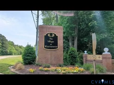 a view of a house with a large tree and a yard
