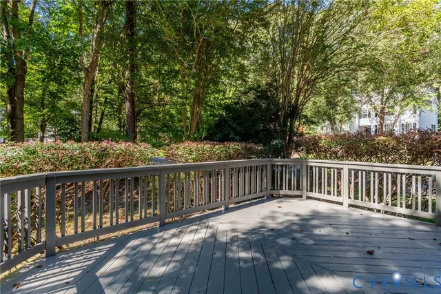 a balcony with wooden floor and fence