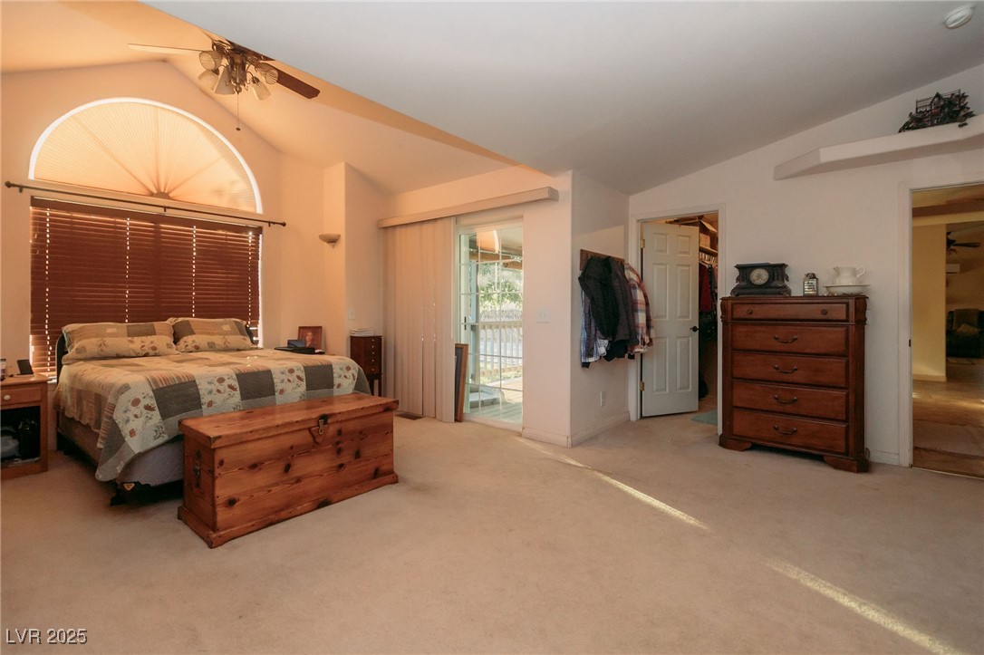 3485 Gally Road Pahrump, NV 89060 - Photo 16 of 90 Bedroom featuring lofted ceiling, access to exterior, carpet flooring, and ceiling fan