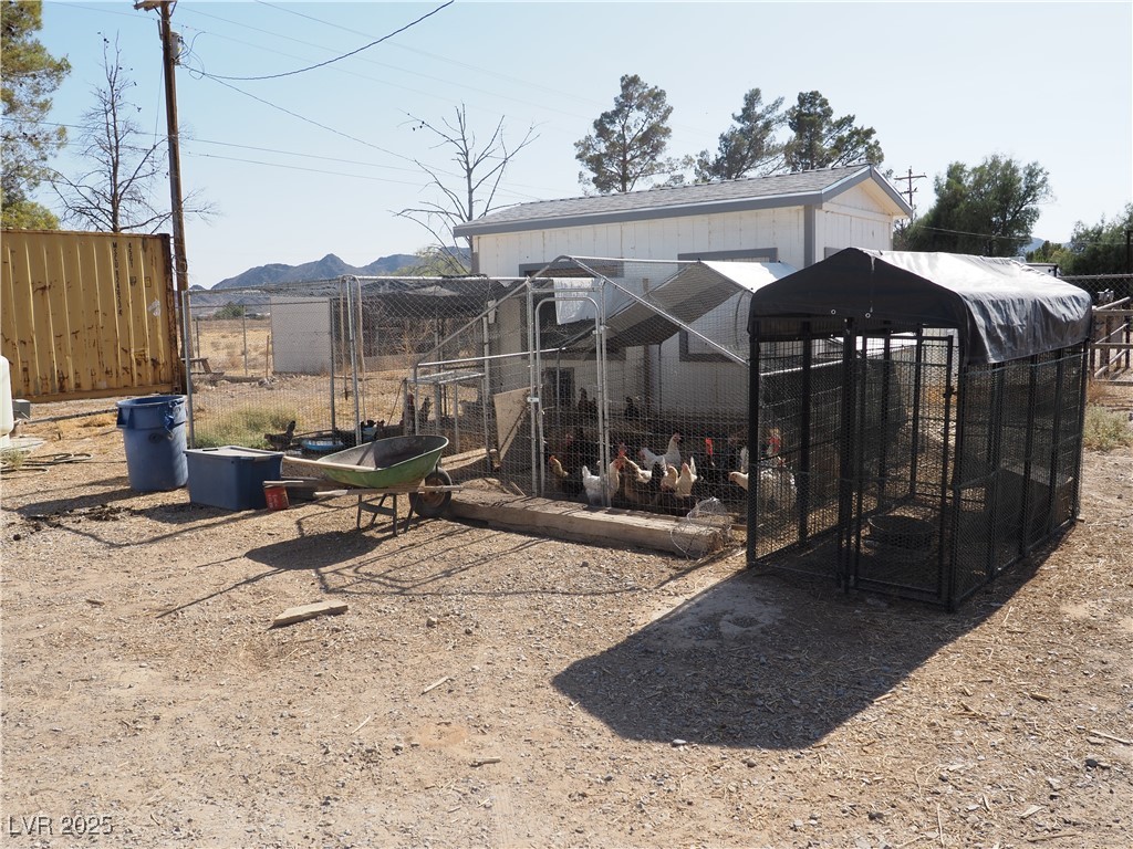 3485 Gally Road Pahrump, NV 89060 - Photo 19 of 90 Back of property with exterior structure and an outbuilding